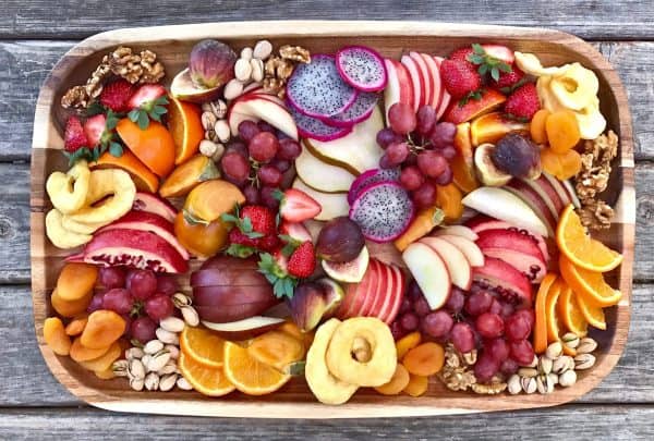 fruit charcuterie board ideas-daily mom-fresh and dried apples, oranges, dragonfruit and more.