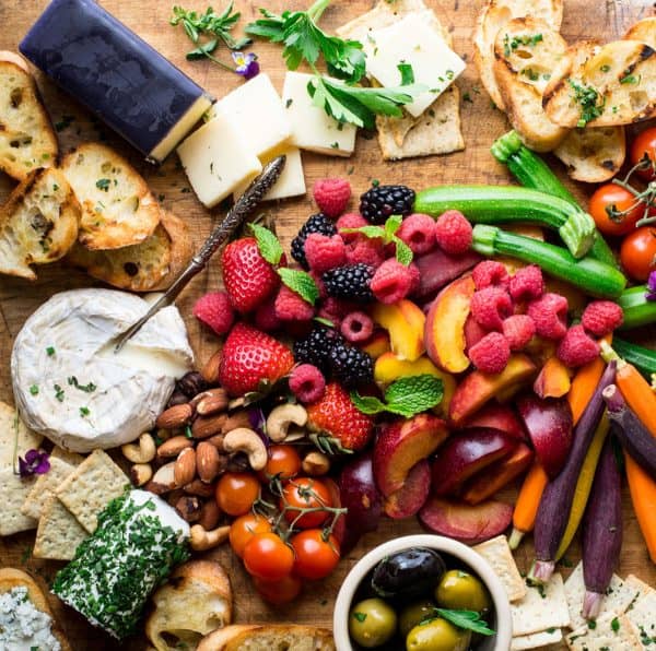 fruit charcuterie board ideas-eating well-board with a variety of fruits, veggies, and cheese
