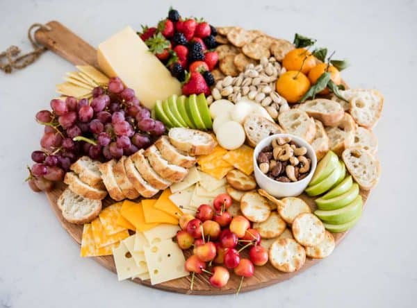 fruit charcuterie board ideas-i heart naptime-board with a variety of fruits, crackers, and cheese.