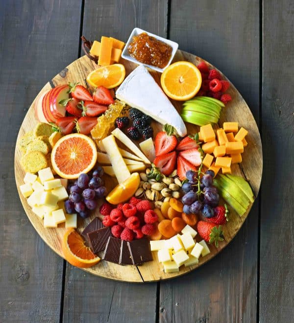 fruit charcuterie board ideas-mondern honey-mix of fruits like blueberries, apples, oranges, and a variety of cheese.