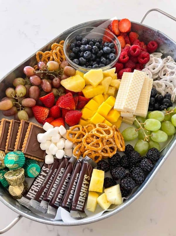 fruit charcuterie board ideas-palate-a metal tray with a variety of fruits and dessert options.
