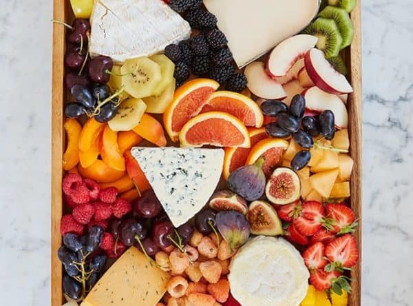 fruit charcuterie board ideas-purewow-a traditional charcuterie board with more fruit