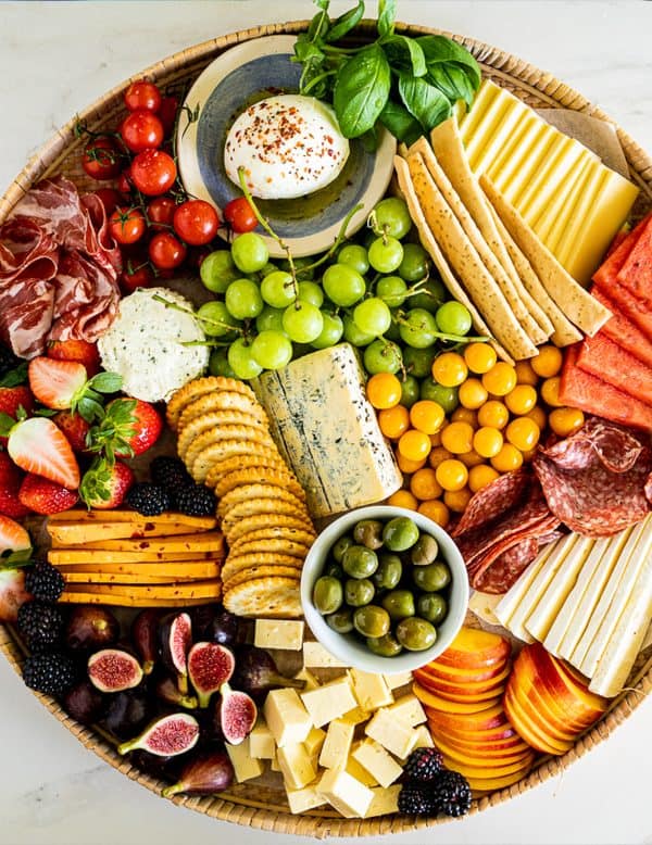 fruit charcuterie board ideas-simply delicious food-board with a variety of fruits, cheeses, and crackers.