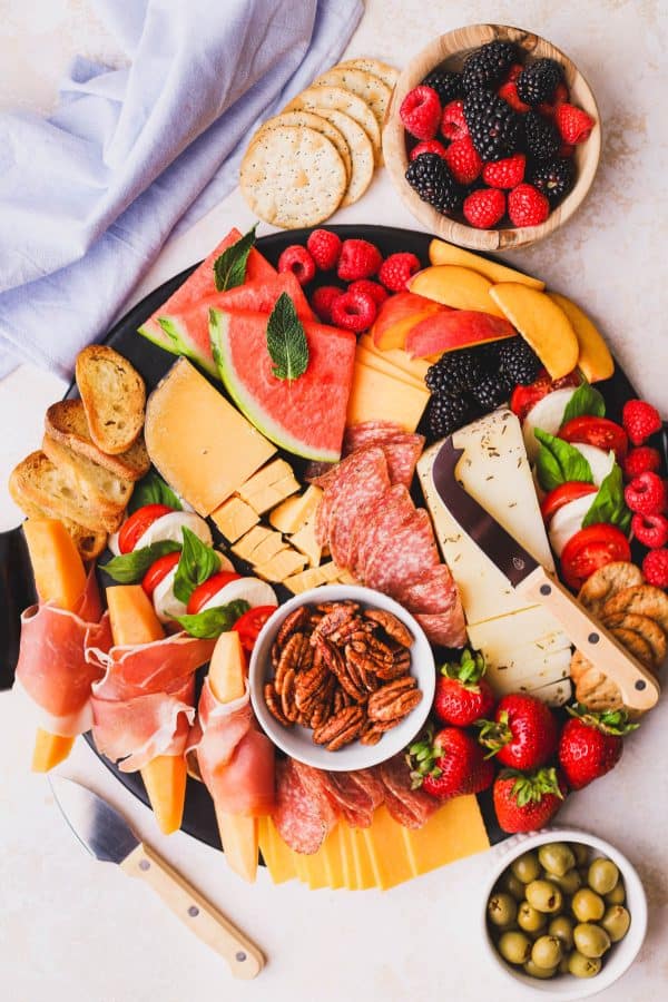 fruit charcuterie board ideas-the epicurean mouse-board with a variety of fruits and other options like cheese and olives.
