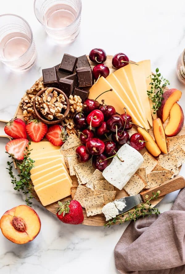 A board full of summer fruits like strawberries, cherries, and peaches from danilicious