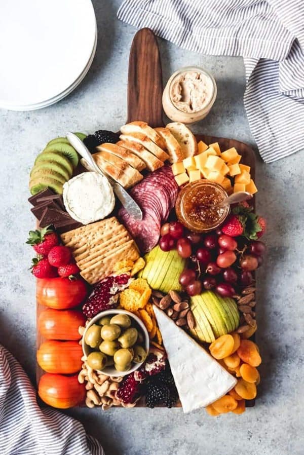house of nash eats with a board full of fruit, veggies, cheese, and more.