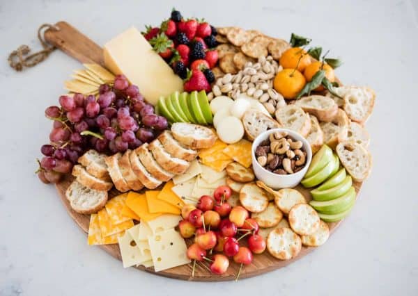 i heart nap time fruit and cheese charcuterie board idea with an array of crackers, fruit, and cheese.