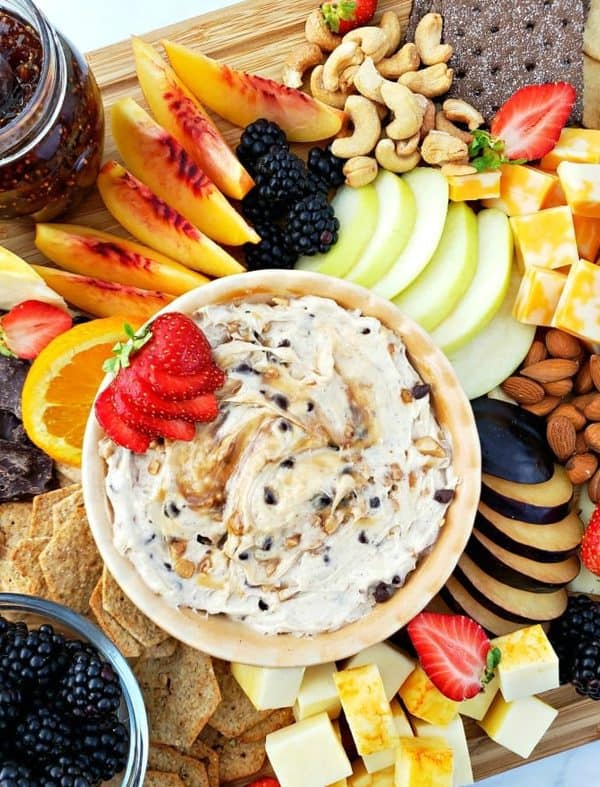 A chocolate chip fruit dip in the center surrounded by a ton of fruit options from juggling act mama.