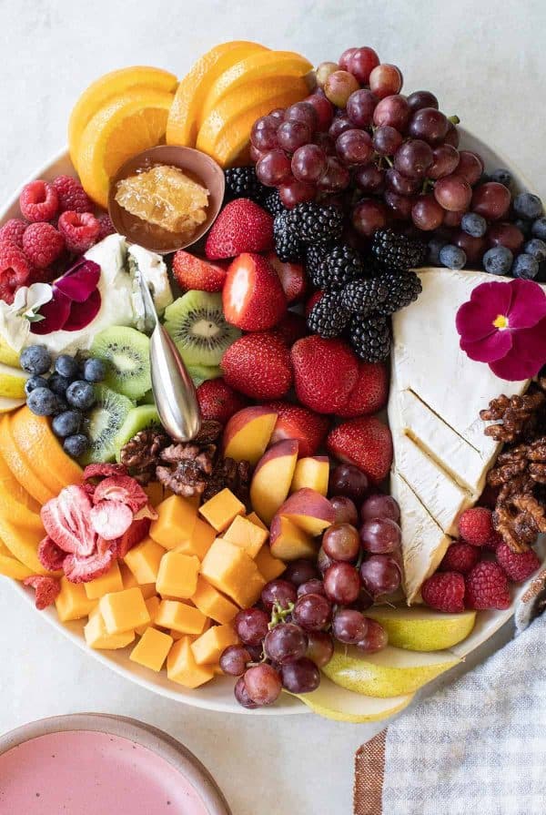 A fruit board that is piled high with different options from sugar and charm