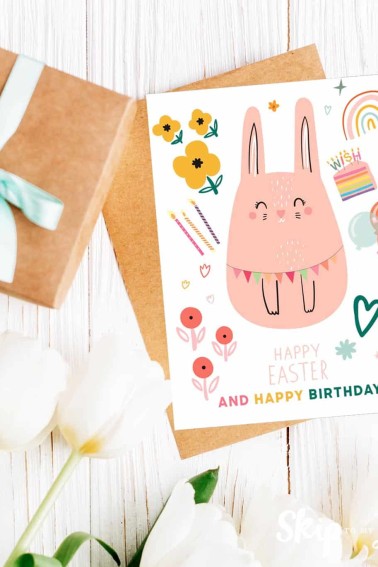 Image shows a happy easter birthday card with white flowers next to it