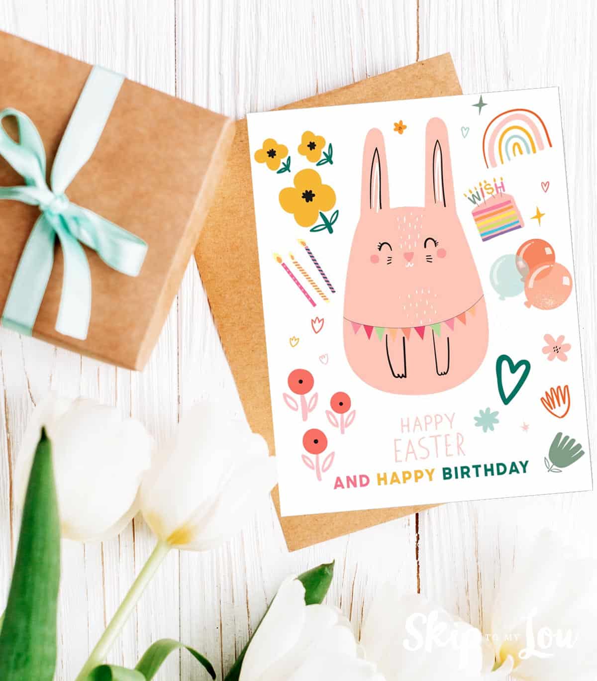 Image shows a happy easter birthday card with white flowers next to it