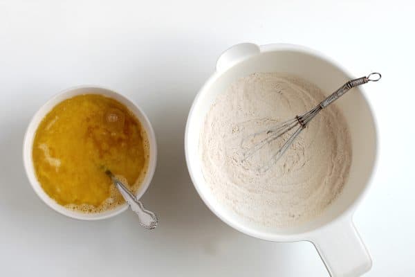 Two mixing bowls. One holding the wet ingredients and the other holding the dry ingredients for paleo bread, by Skip to my Lou.
