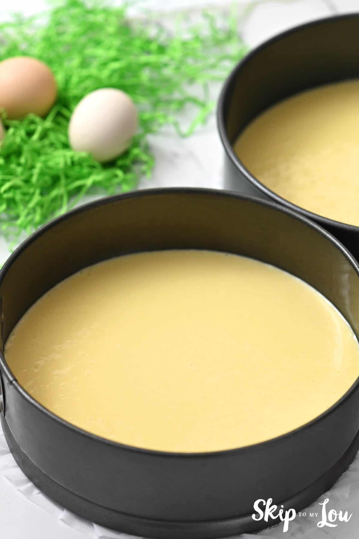 Two sliver springform pans with cake batter inside, by Skip to my Lou.