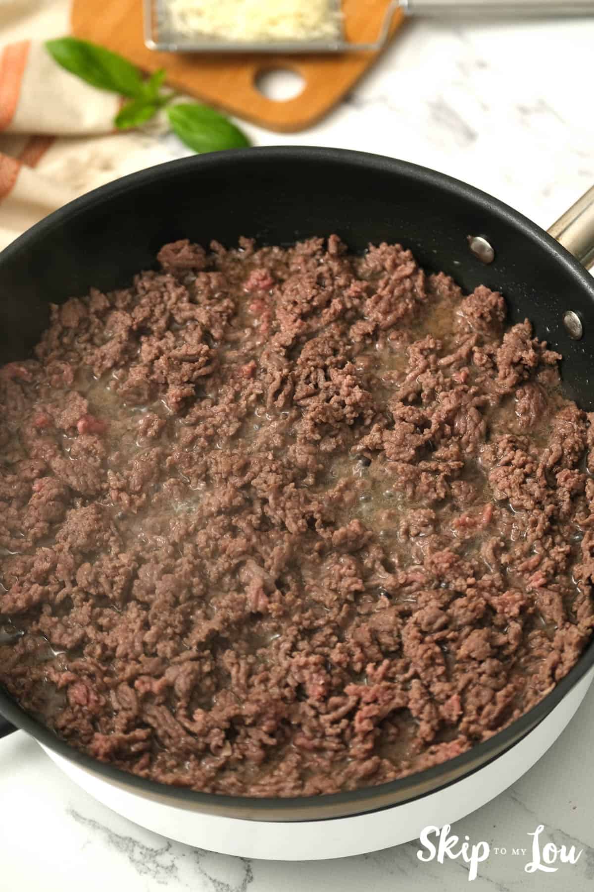 Ground beef browning in a skillet, by Skip to my Lou.