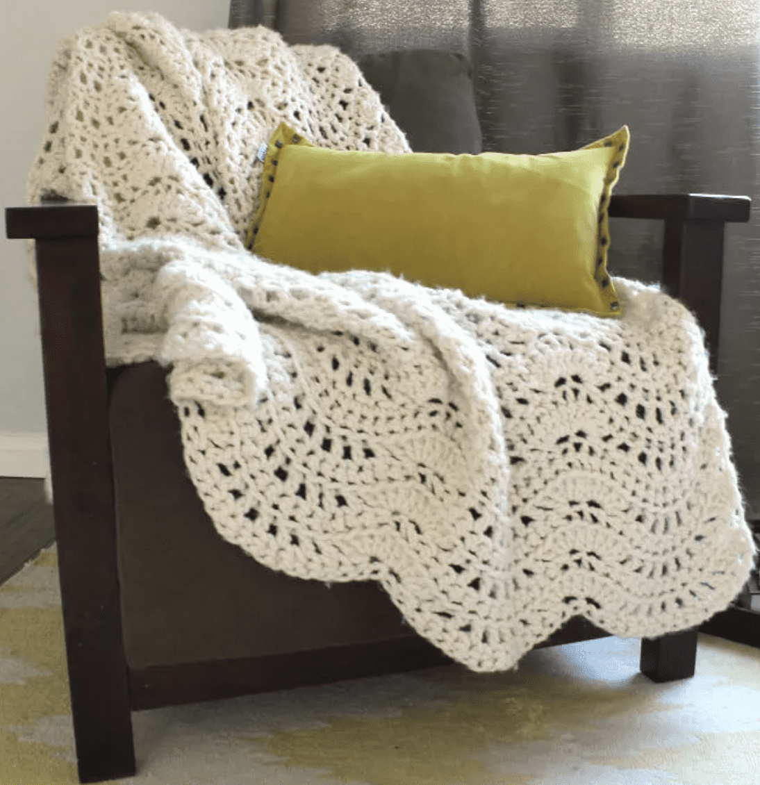 ivory chunky feather and fan afghan on green chair