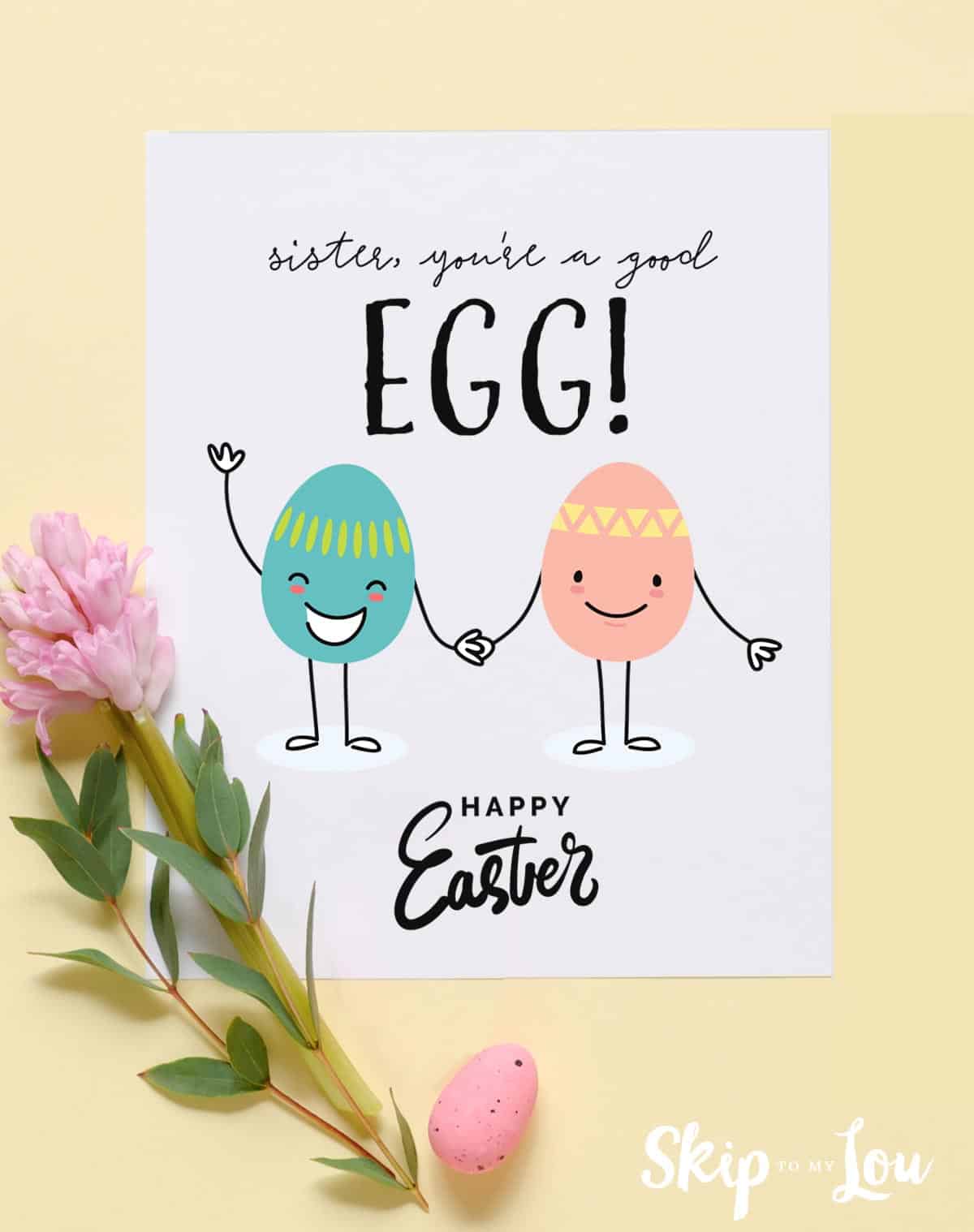 Image shows a printed Happy Easter sister greeting card decorated with pink and green eggs over a yellow background. From Skip to my Lou