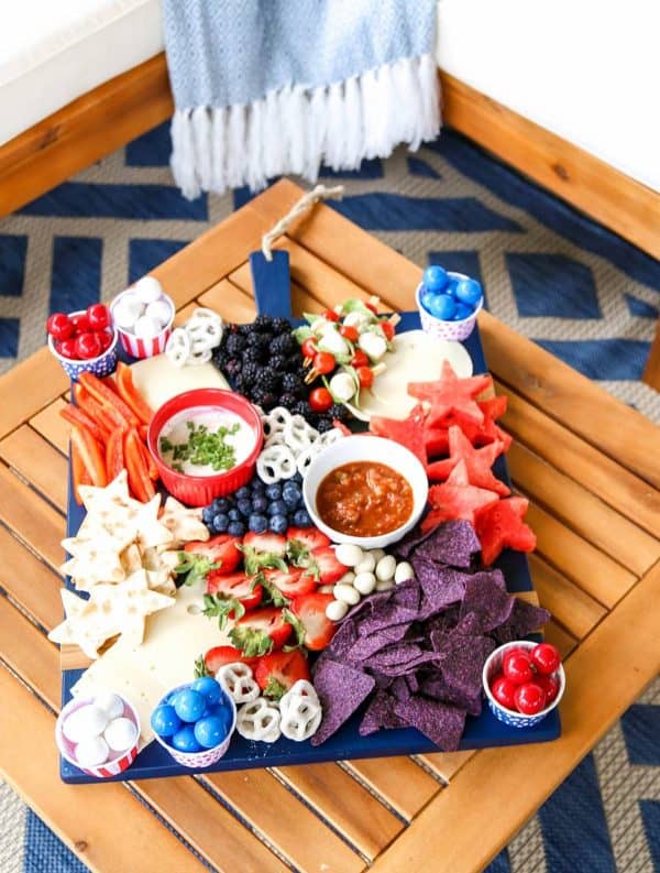 One of the nicest 4th of july charcuterie board ideas comes from A blissful nest. It has multiple dips, strawberries, mozzarella, watermelon stars, and plenty of crackers and chips.