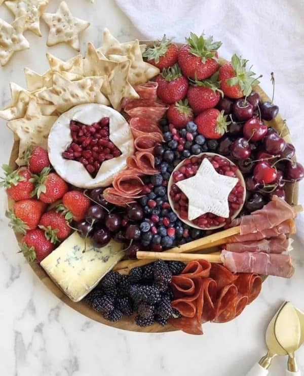 if you're looking for 4th of july charcuterie board ideas ain't too proud to meg has a simple one full of pomegranate seeds, meat, cheese, fruit and more.
