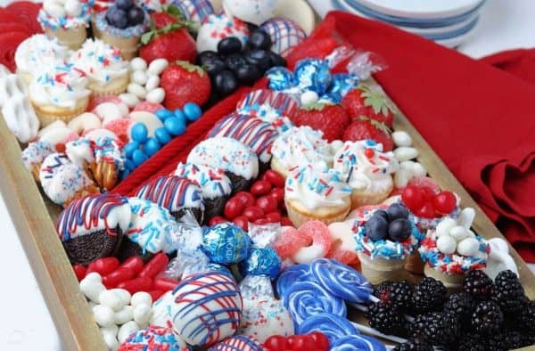 full of red, white, and blue desserts, candies, and even some fruit this board is from reinvented mom.