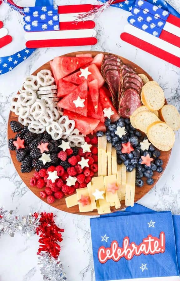 one of the simplest 4th of july charcuterie board ideas includes watermelon, chocolate covered pretzels, blueberries, meat, and more from attempts at domestication.