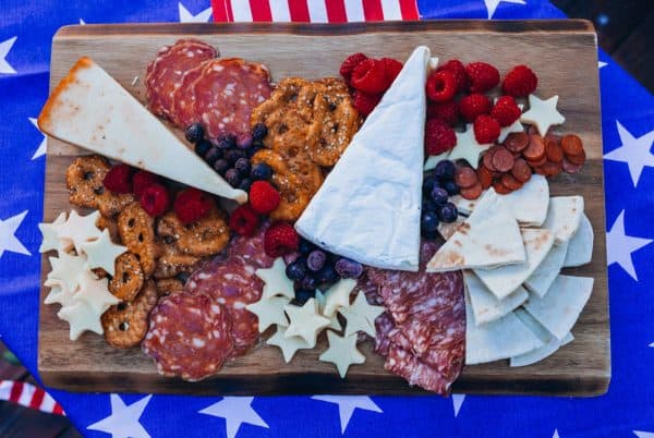 4th of july charcuterie board ideas with ice cream and neon dreams. star cheese, fruits, pretzel, thins and more on the board. 