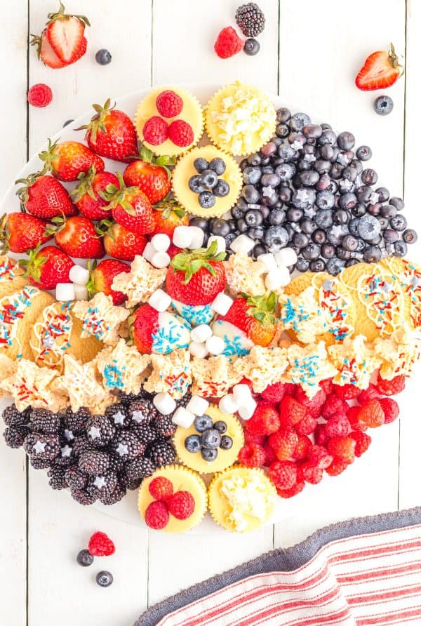a patriotic dessert board with cupcakes, rice treats, and fruit from play party plan