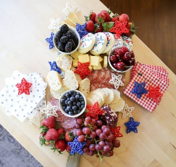 a loaded board from sbk living with fruit, cheese, cookies, and more.