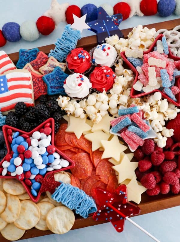 the Denver housewife includes sour candies, cheese stars, cookies, cupcakes, popcorn and more on her 4th of july charcuterie board.