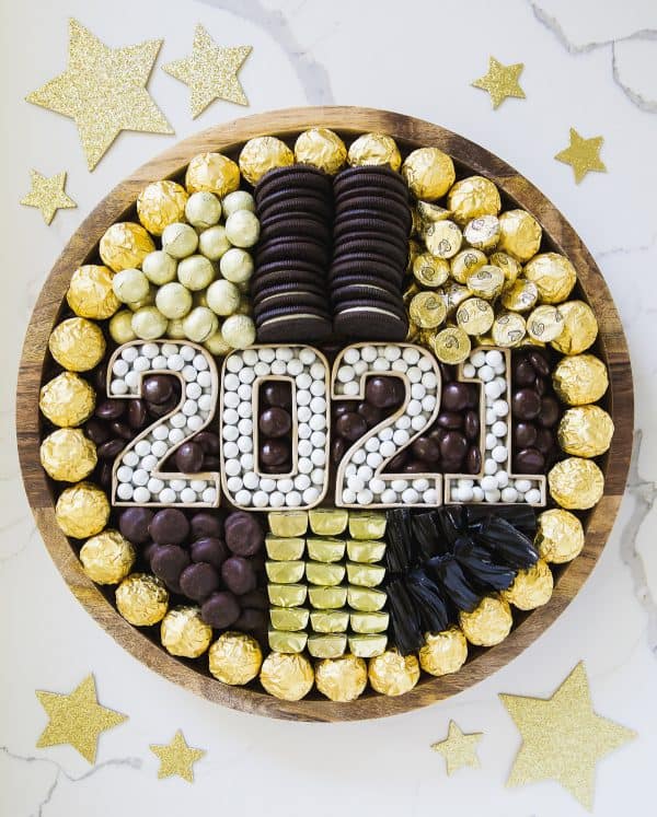 A pumpkin and a princess created a gold and black board with Oreos, gold candies, and more.