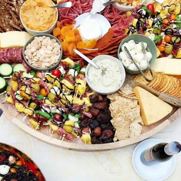 The Reluctant Entertainer's graduation charcuterie board includes mini tortellini, mozzarella, fruits, cheese, and more. 