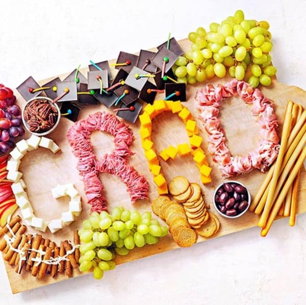 Grad written out in meat and cheese with candy graduation hats from Savory Online.