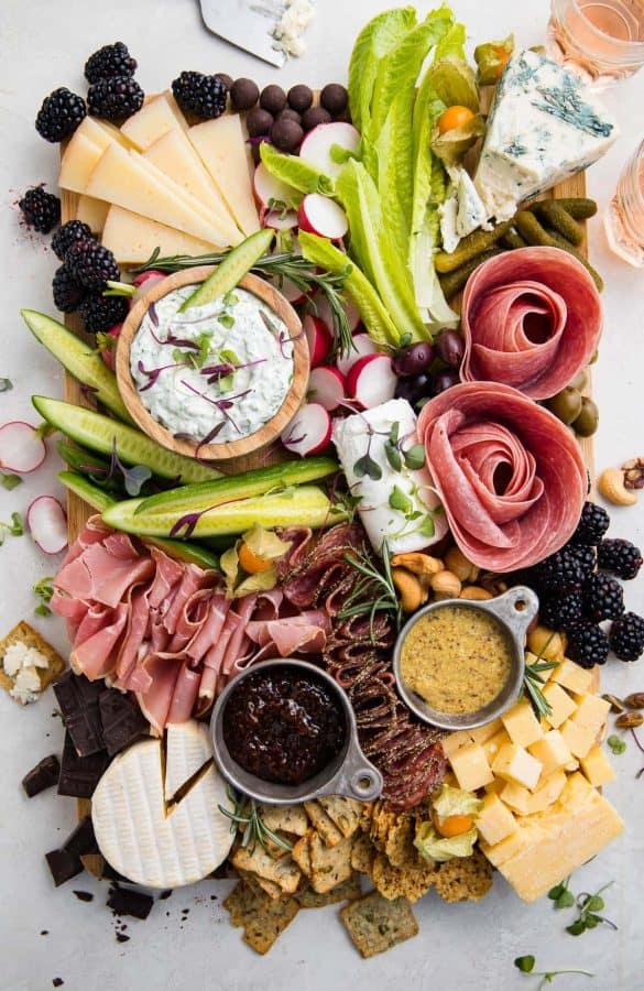 40 aprons has a large board with meat, cheese, and many dips for their keto charcuterie board ideas