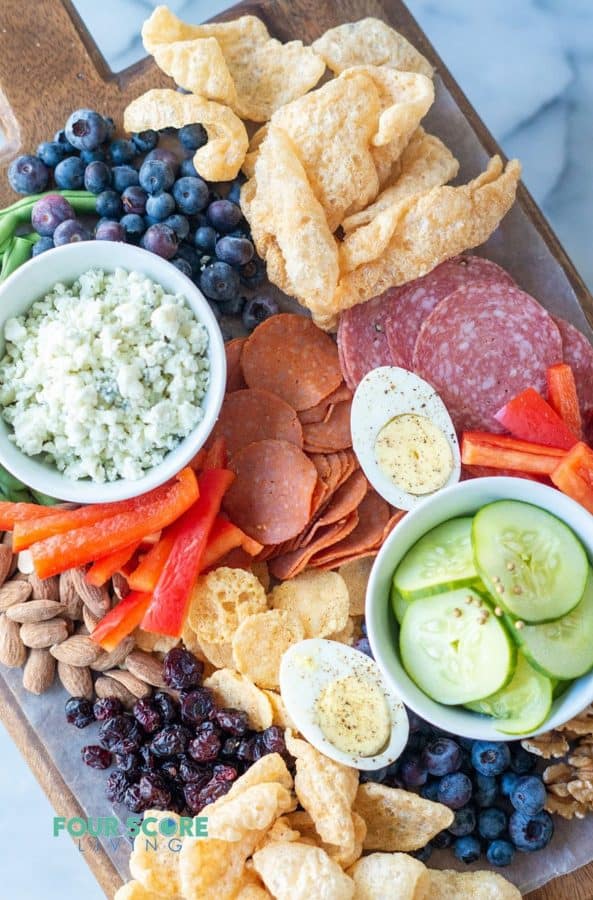 keto charcuterie board ideas from four score living with pork rinds, veggies, and dips