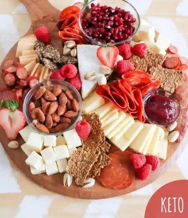 a valentine's day keto charcuterie board with red fruits, cheese, and meat from homemade heather