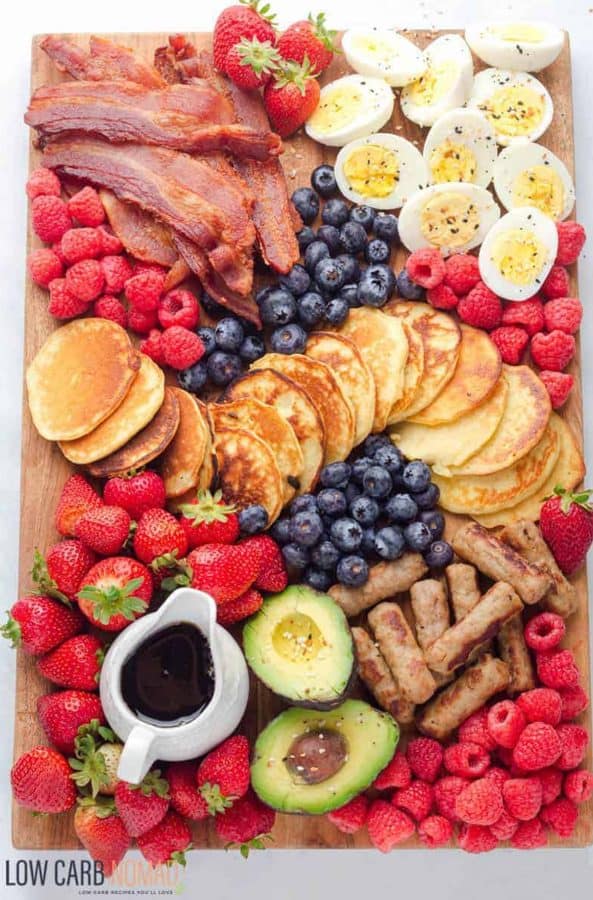 breakfast board from low car nomad with hard boiled eggs, avocado, fruit, and pancakes