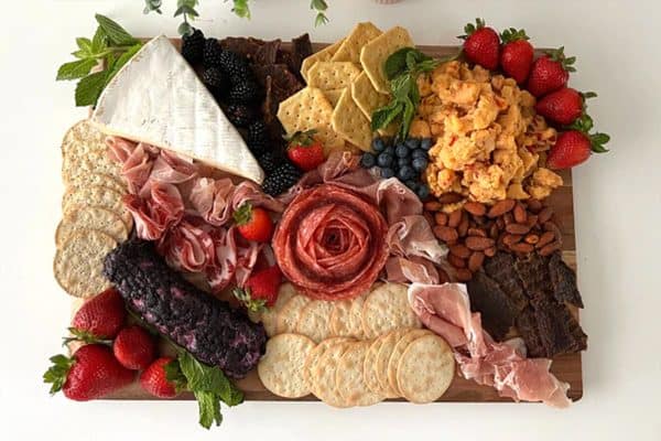 people's choice beef jerky- a beautiful board with meat, cheese, fruit, and crackers