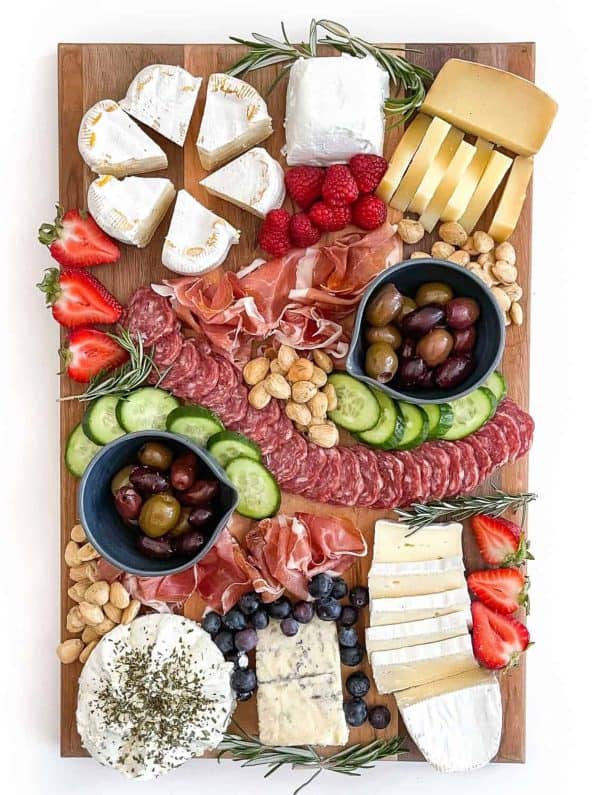 tastes lovely has a cheese platter with meat,cheese, veggies, and bowls of olives