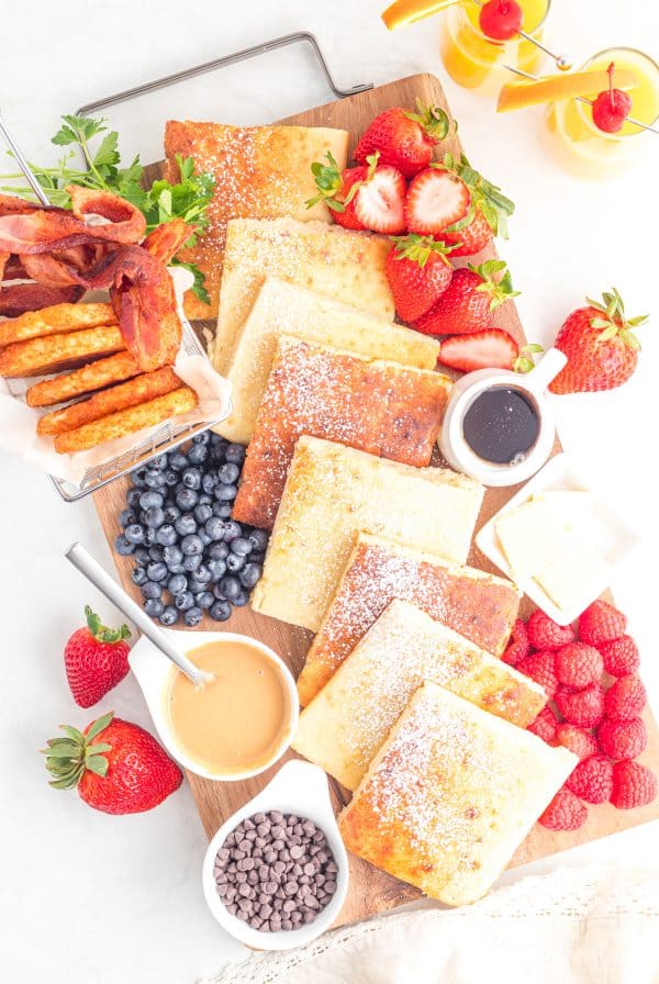 sheet pan pancakes with blueberries, strawberries, and more from all you need is brunch