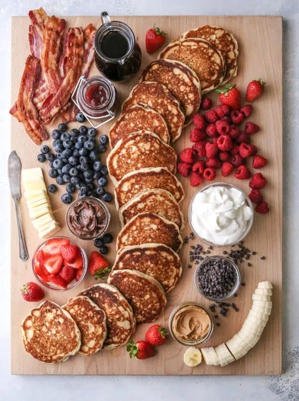 a understated board with pancakes, blueberries, raspberries, and more from Completely Delicious.