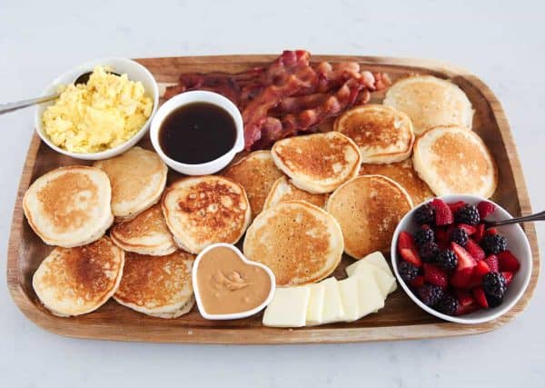i hear naptime with a charcuterie board full of pancakes, butter, eggs, and more.