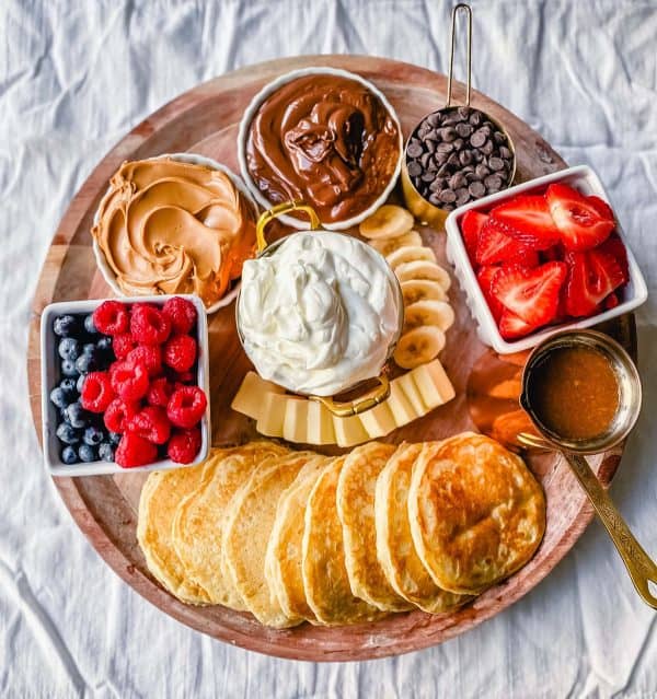 modern honey with pancakes, fruit, and delicious whipped cream 