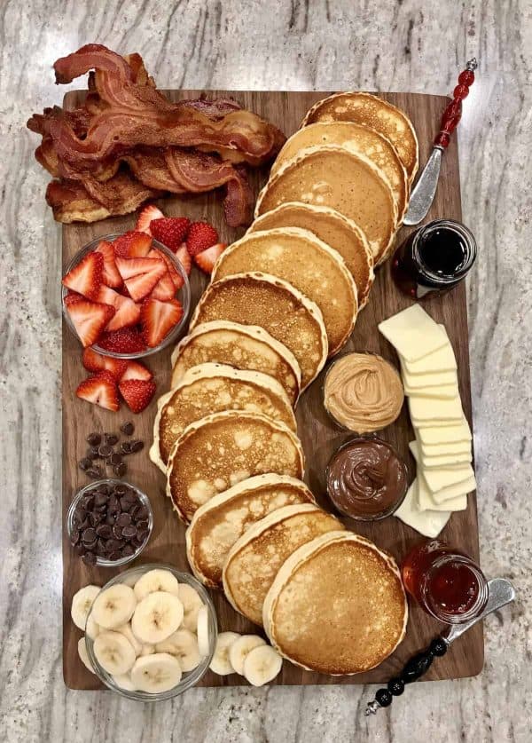 The baker mama makes a simple board with pancakes, fruit, and toppings. 