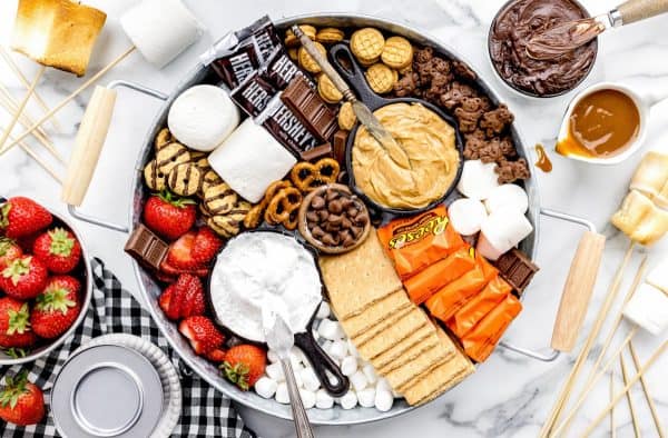 Lil' Luna makes a delicious s'mores board with fluff, peanut butter, cookies, and candies. 
