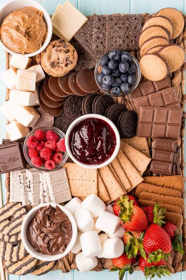 a large board with crackers, strawberries, chocolate, cookies, dips, and delicious treats fromPlay Party Plan
