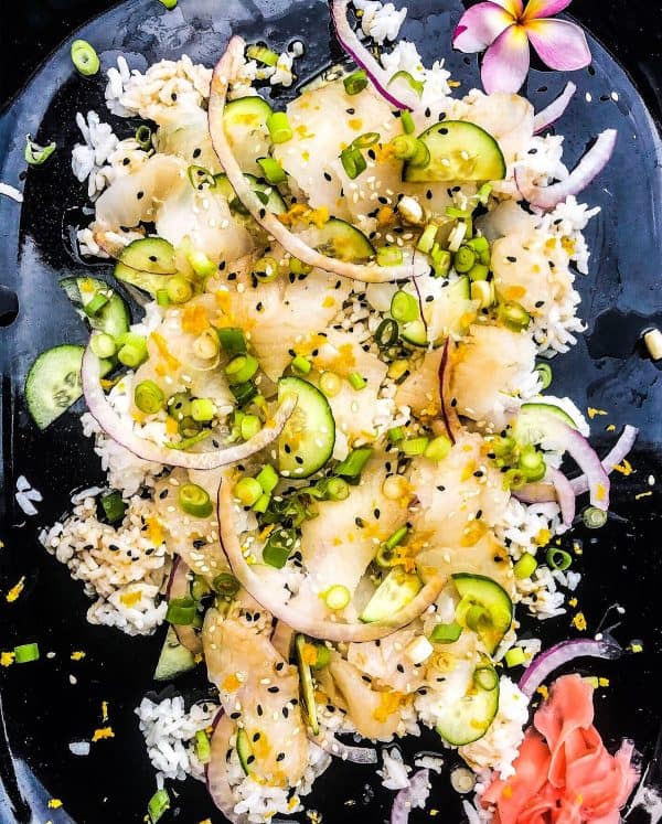 a messy sushi board with fish, cucumber, onion, and more from Valentine Thomas 