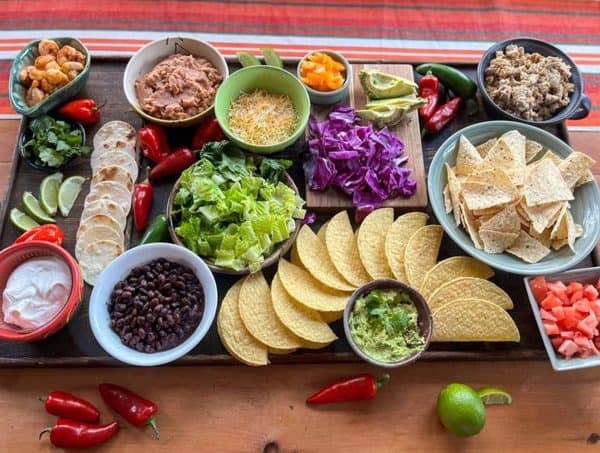 Mini everything with mini hard and soft shells, chips and bowls of taco stuffings make this one of the best taco charcuterie board ideas from Amazing Charcuterie Boards.