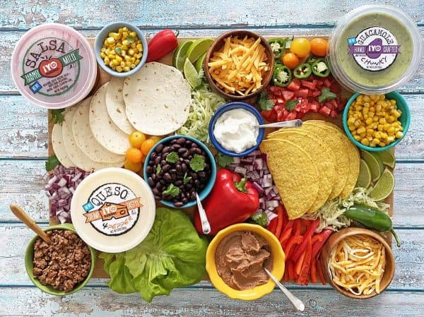 A classic make your own taco board. Healthy Family project includes a variety of dips, veggies, toppings. 