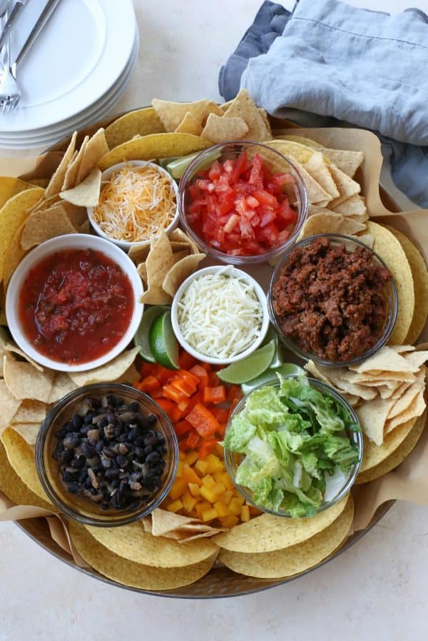 A bowl for everything surrounded by nacho chips, and hard shell tacos from Hip foodie mom.