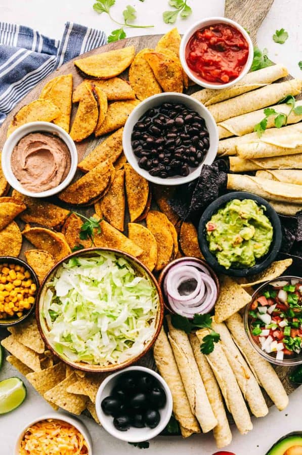An easy to make (mostly pre-made) charcuterie board from The recipe critic with mini tacos and taquitos.