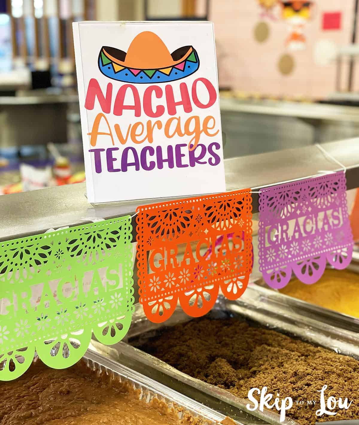 Papel picado banner that says "Gracias" in green, orange and purple for Teacher appreciation week. The card on top reads Nacho Average Teachers